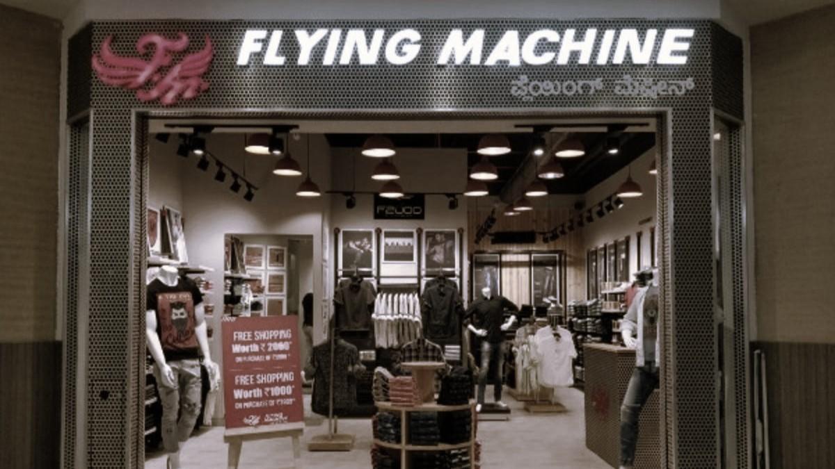 Modern clothing store with stylish racks, ambient lighting, and open layout displaying men's and women's fashion wear